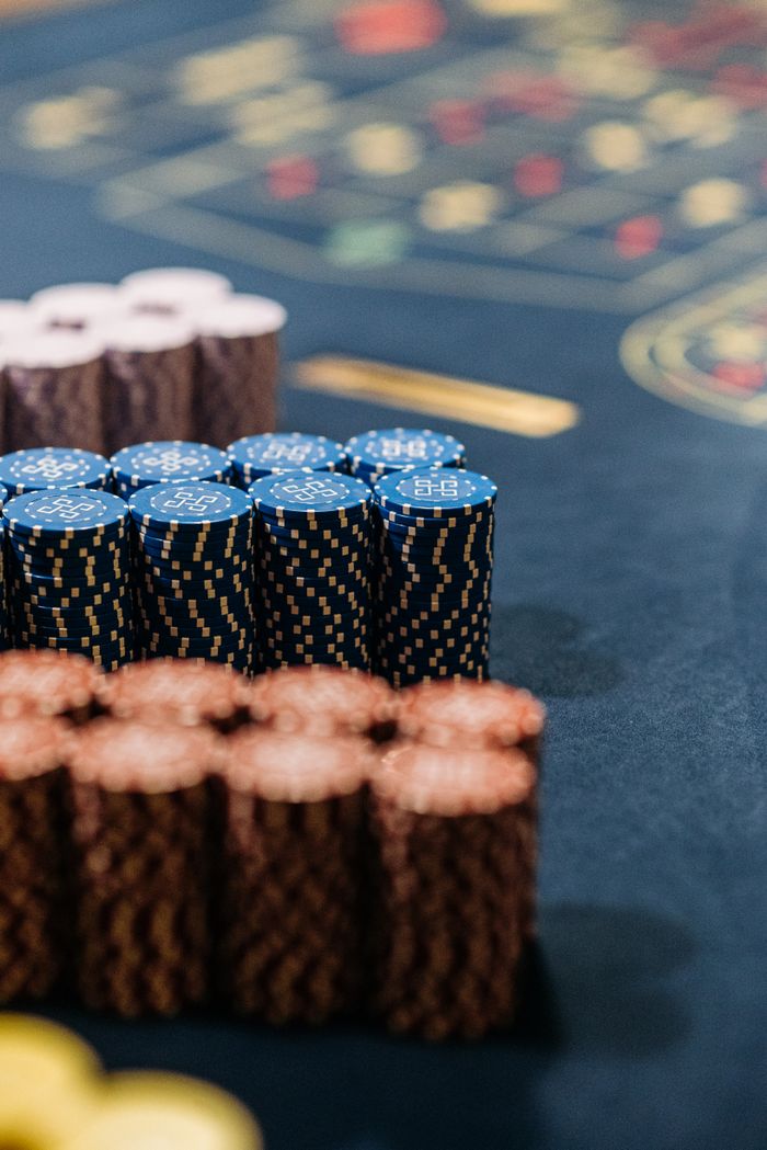 Services Close-up of colorful stacked casino chips on a roulette table.